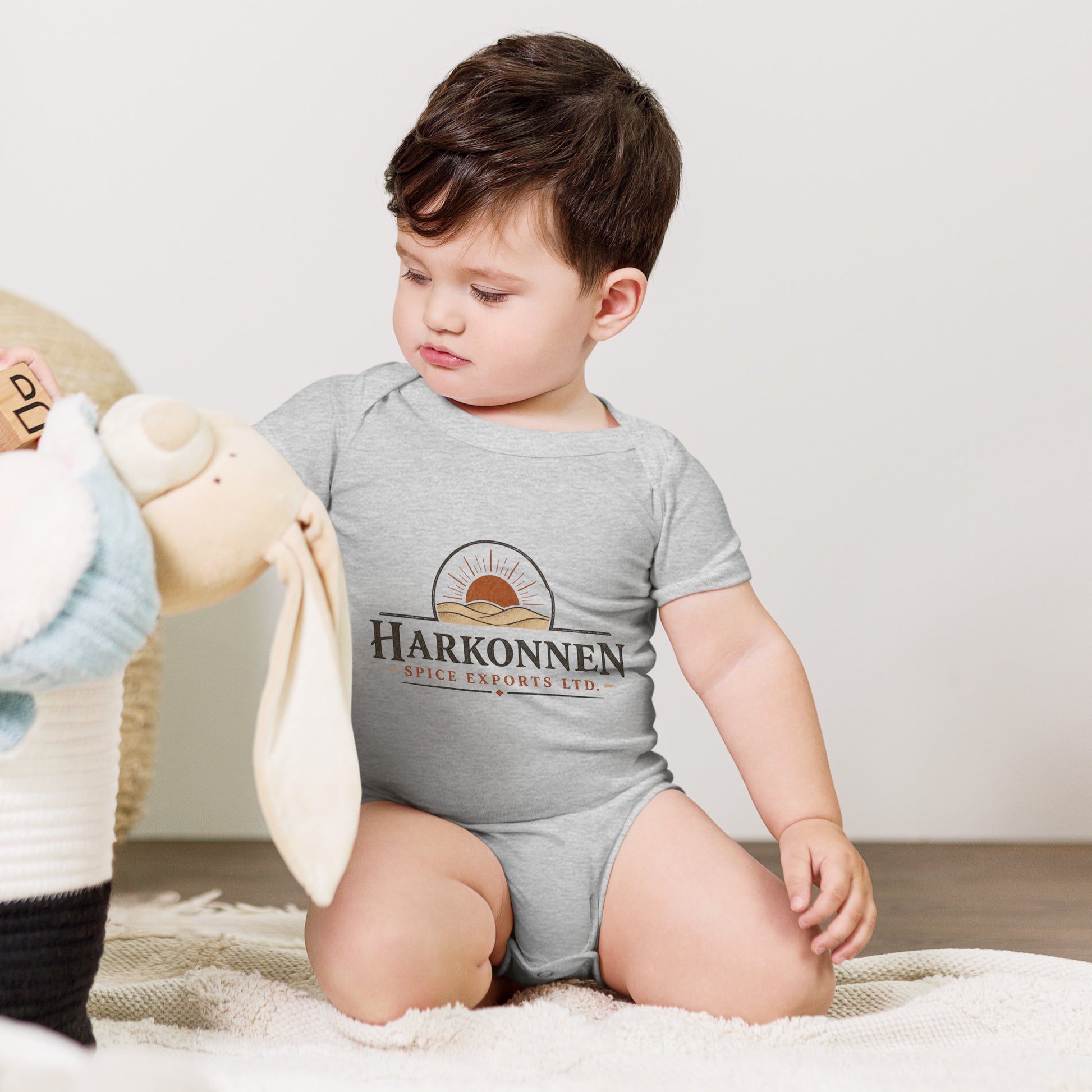 Baby bodysuit with a fictional trading company logo for Harkonnen Spice Exports Ltd