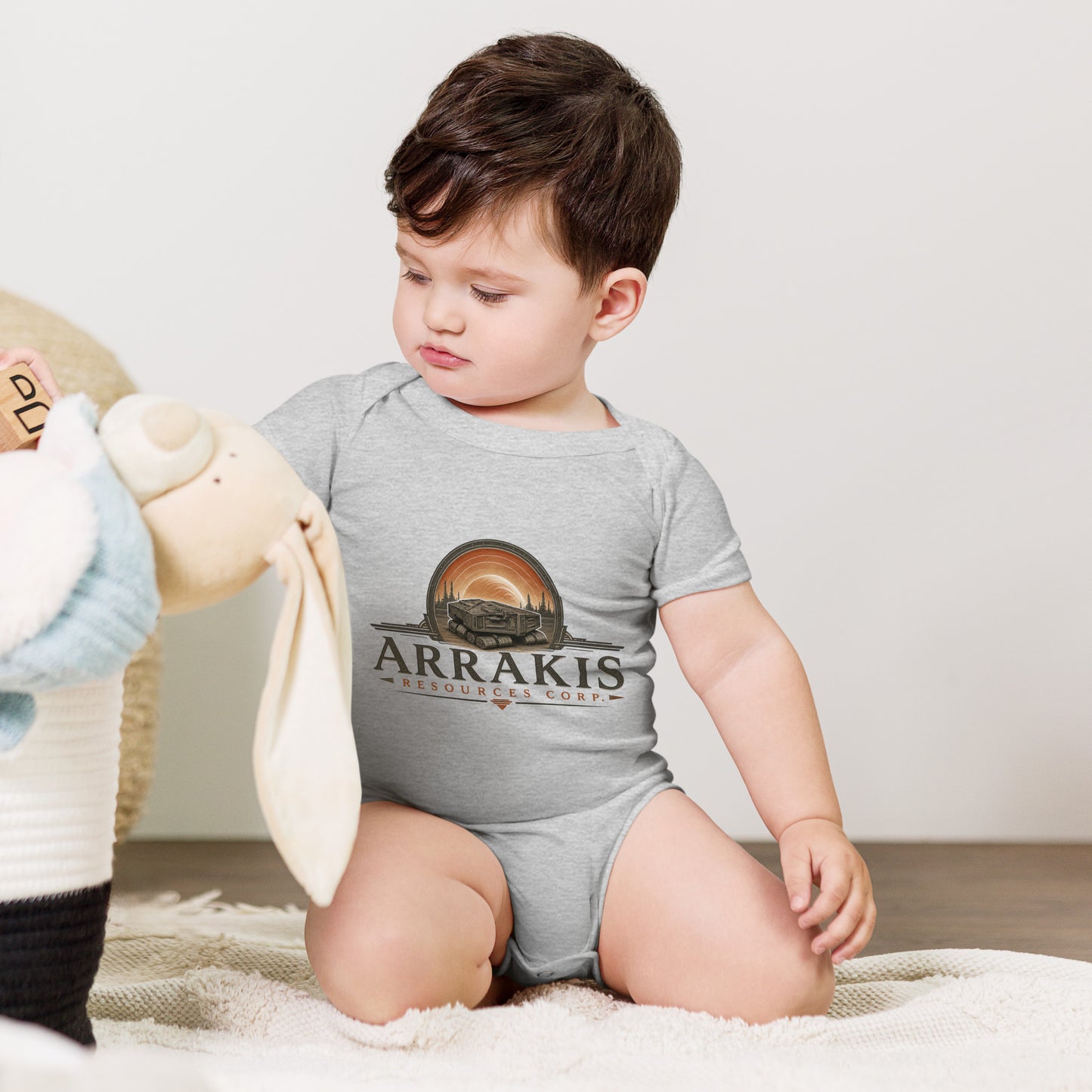 Baby bodysuit with a fictional mining company logo for Arrakis Resources Corp