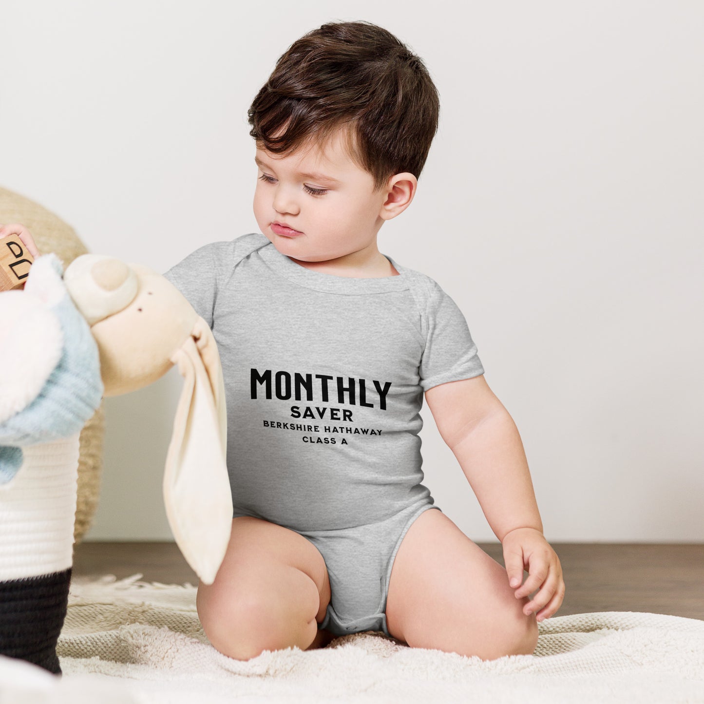 Baby bodysuit with a monthly saver design referencing a high-priced share class