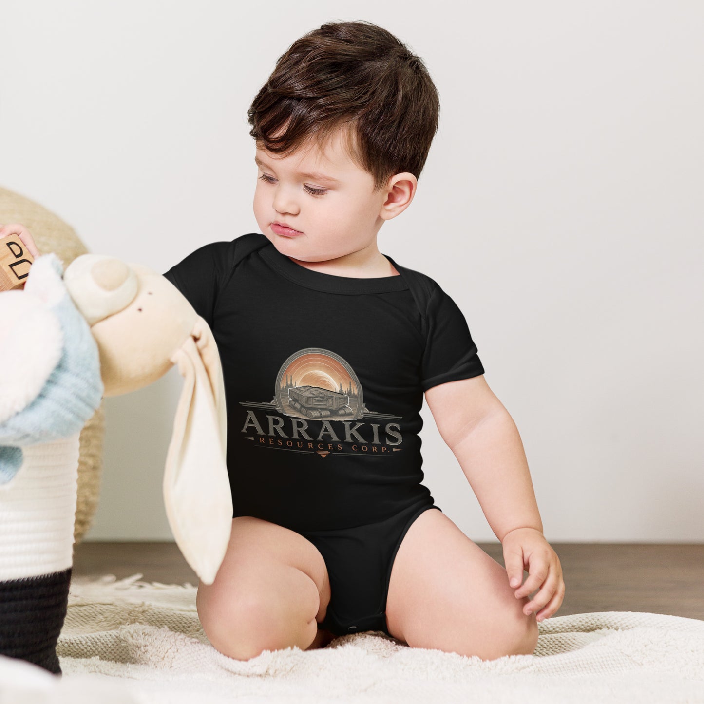 Baby bodysuit with a fictional mining company logo for Arrakis Resources Corp