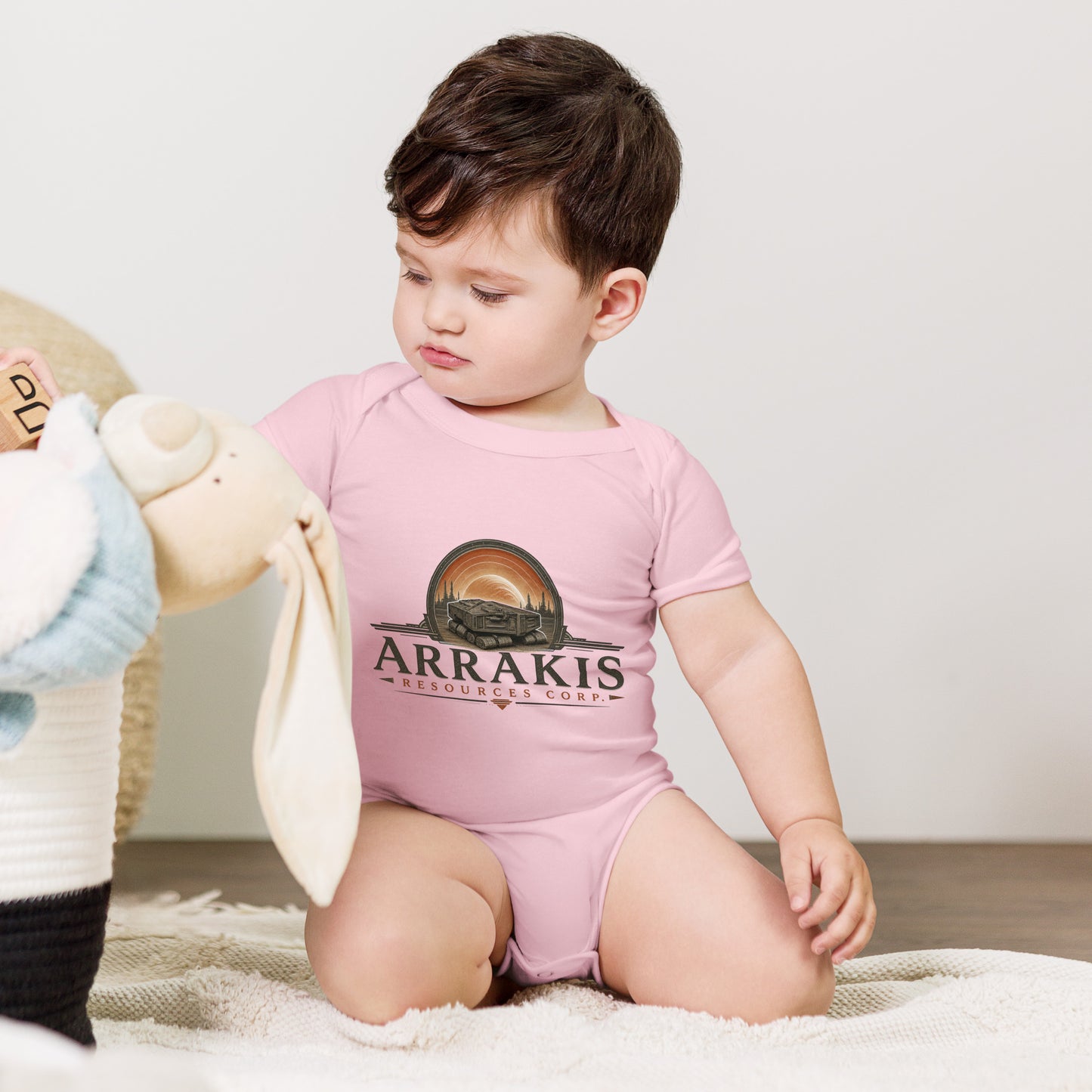 Baby bodysuit with a fictional mining company logo for Arrakis Resources Corp
