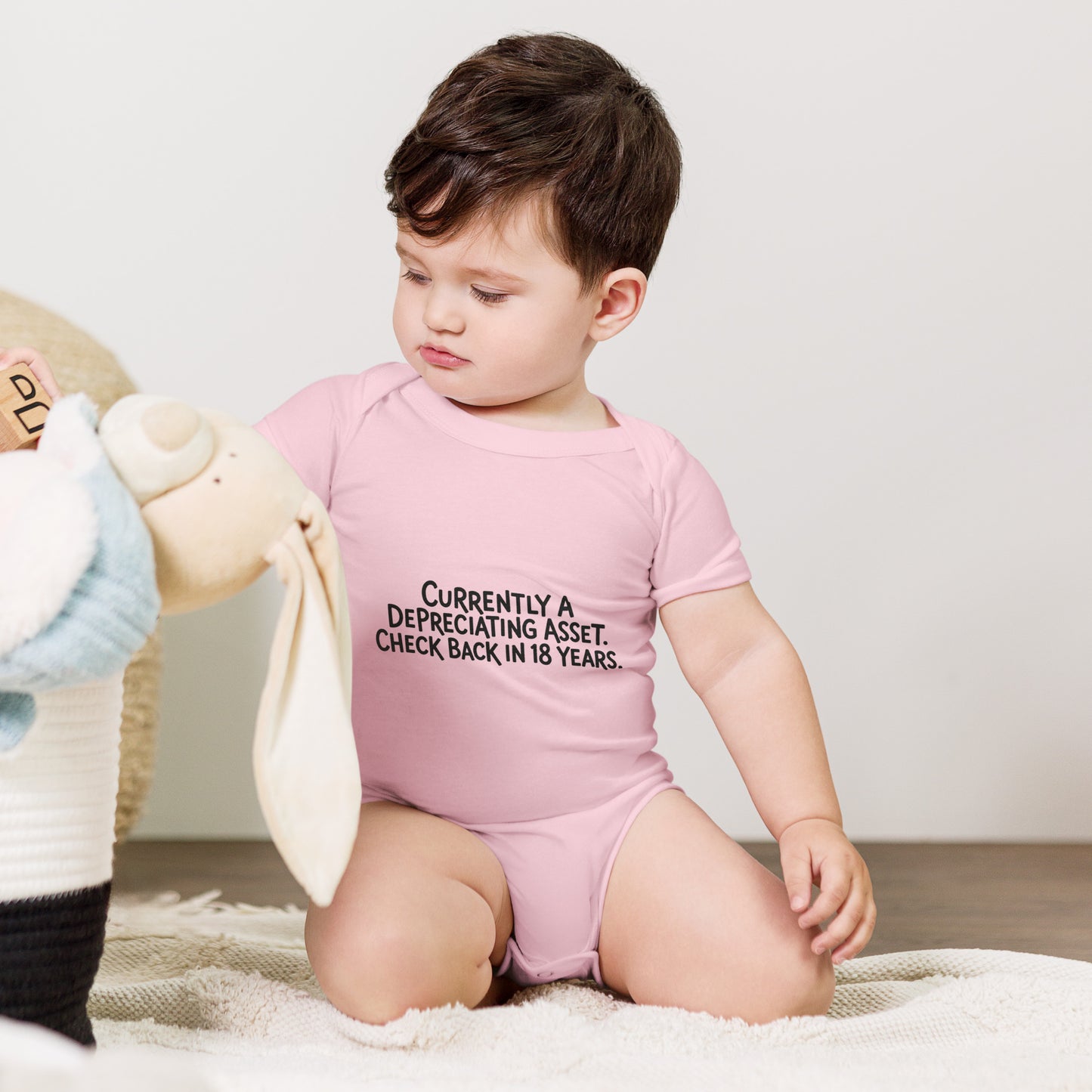 Baby bodysuit with the words Depreciating asset, check back in 18 years