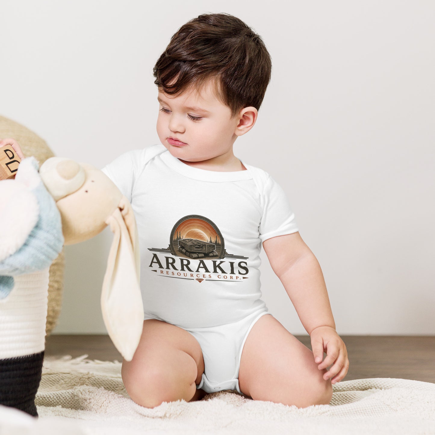 Baby bodysuit with a fictional mining company logo for Arrakis Resources Corp