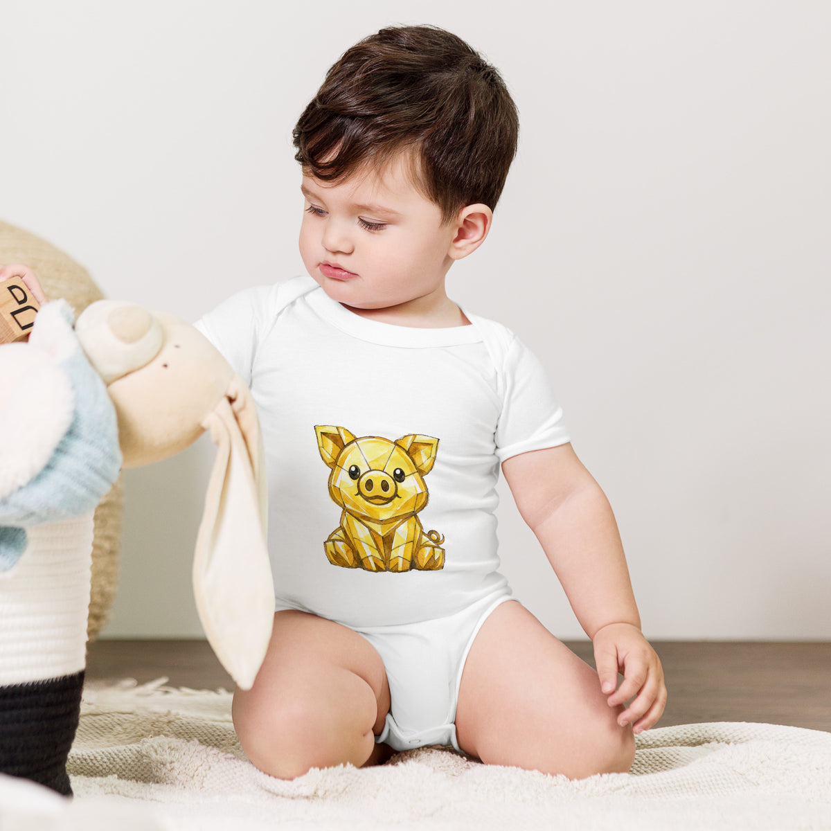 Baby bodysuit with a golden piggy print, worn by a baby