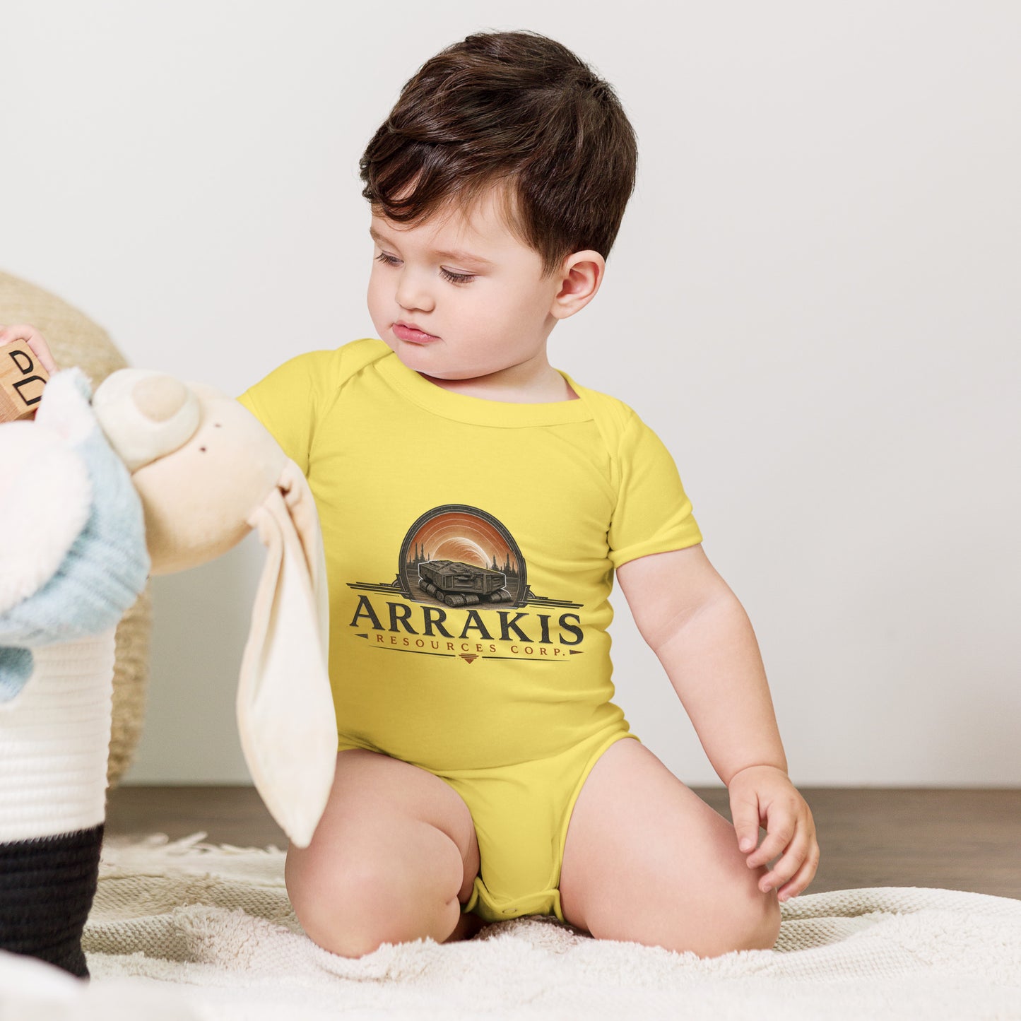 Baby bodysuit with a fictional mining company logo for Arrakis Resources Corp