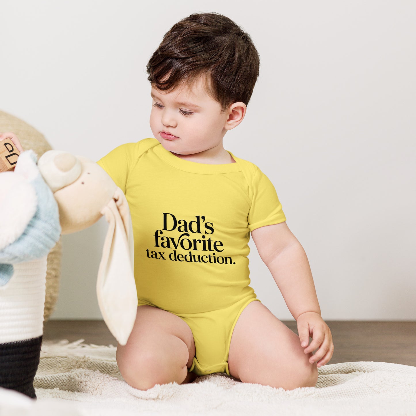 Baby bodysuit with the words Dad's favorite tax deduction