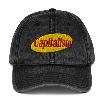 "Capitalism" in retro sitcom-style lettering on a vintage washed cotton twill cap