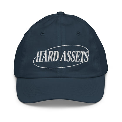 Youth baseball cap with the words Hard Assets in a serif typeface inside an oval badge outline