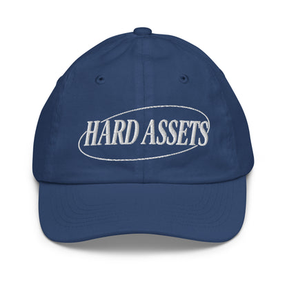 Youth baseball cap with the words Hard Assets in a serif typeface inside an oval badge outline